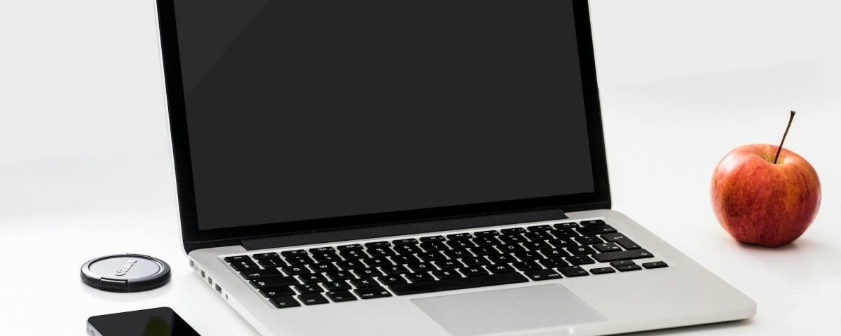 macbook pro near iphone and apple fruit