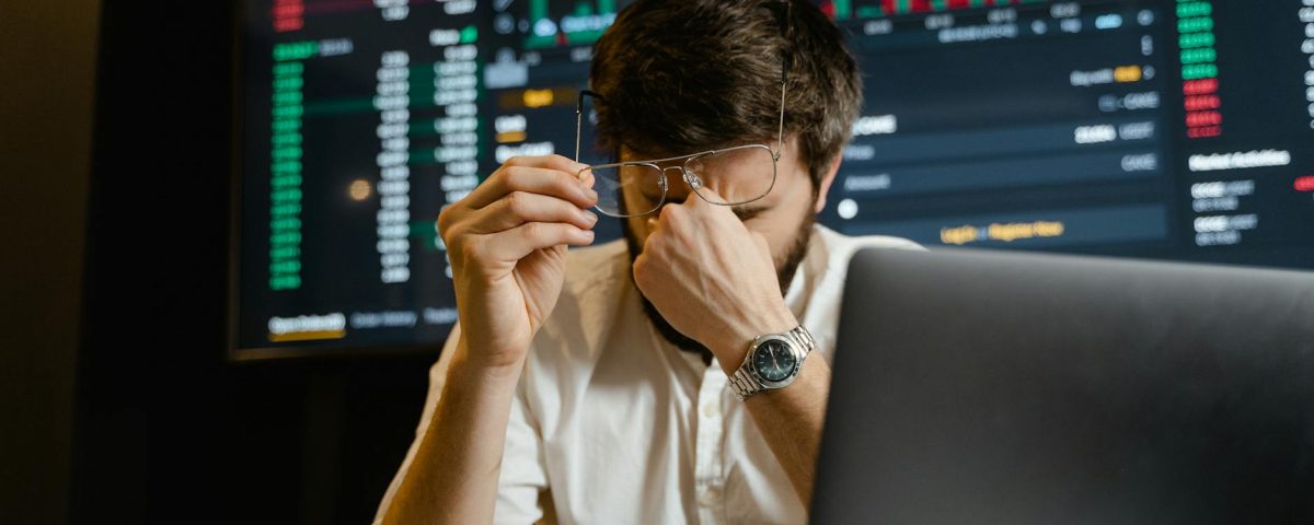 man in white dress shirt using black laptop computer